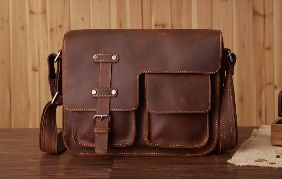 Buckled leather messenger bag, Brown, on a table