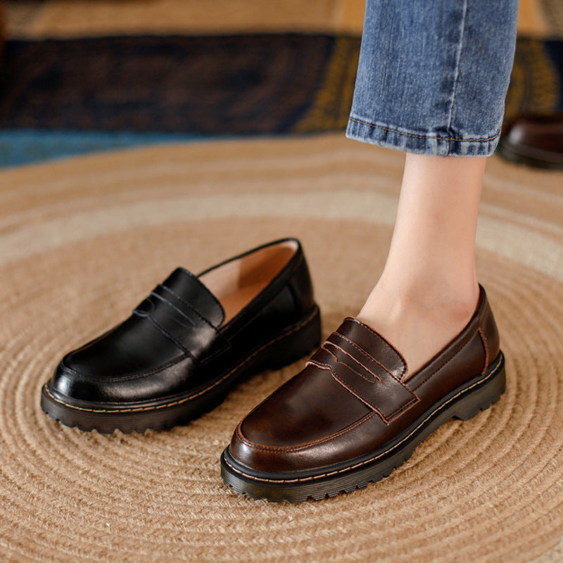 Lug sole penny loafers, Black and Brown, on foot