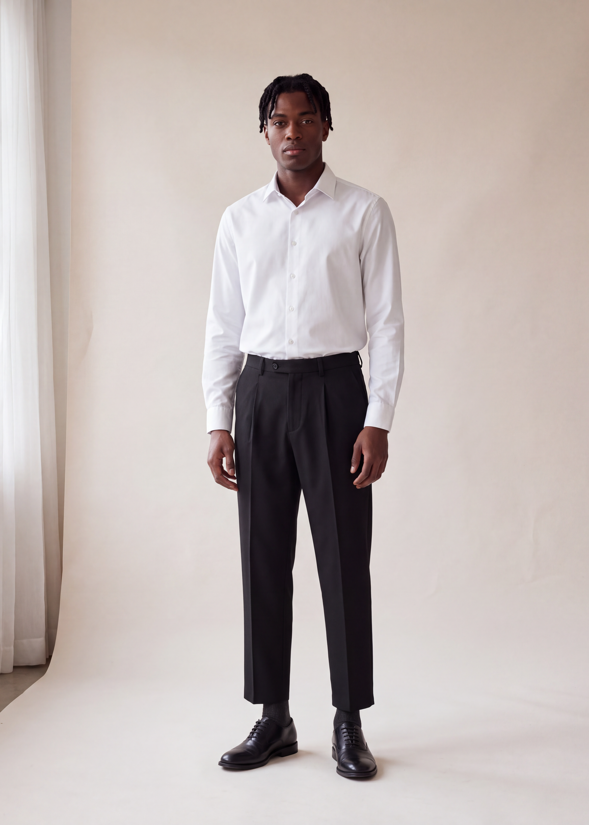 Pleated tapered trousers, Black, worn full length in the studio